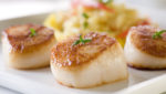 Seared sea scallops with orzo and vegetables. Credit: Northern Wind
